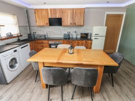 A kitchen with a table and chairs at Meadow View in Laugharne