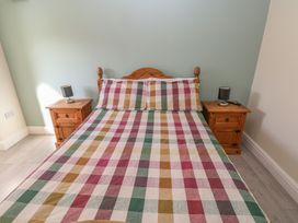 A bedroom with a bed and bedside tables at Meadow View in Laugharne