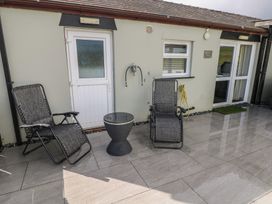 An outdoor area with seating and a table at Meadow View in Laugharne