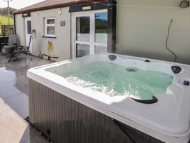 A hot tub with water in an outdoor area at Meadow View in Laugharne