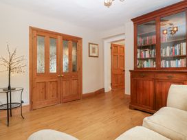 A snug with wooden doors and bookshelf at The Croft Vowchurch near Peterchurch