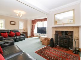A living room with a sofa, tv, and fireplace at The Croft in Vowchurch near Peterchurch