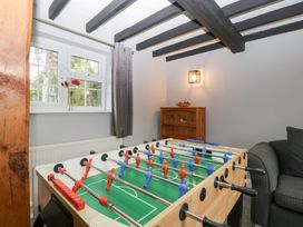 A snug with a foosball table and sofa at The Croft Vowchurch near Peterchurch