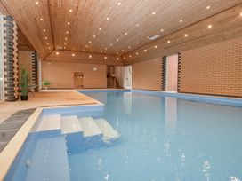 An indoor pool with steps and potted plants at The Croft in Vowchurch near Peterchurch