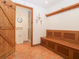 An entryway with bench and mirror at The Croft in Vowchurch near Peterchurch