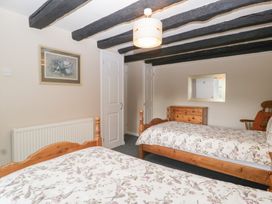 A bedroom with two beds and a mirror at The Croft in Vowchurch near Peterchurch