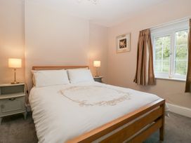 A bedroom with a bed and nightstand at The Croft in Vowchurch near Peterchurch