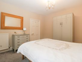 A bedroom with a bed and wardrobe at The Croft in Vowchurch near Peterchurch