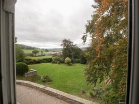 A view of a garden with trees and lawn at The Croft in Vowchurch near Peterchurch