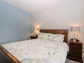 A bedroom with a bed and nightstand at The Croft in Vowchurch near Peterchurch