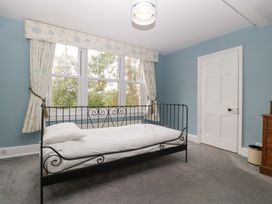 A bedroom with a bed and windows at The Croft in Vowchurch near Peterchurch