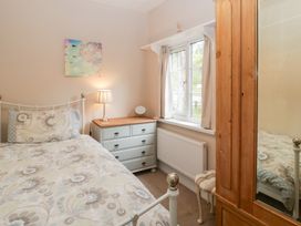 A bedroom with a bed, chest of drawers, and window at The Croft in Vowchurch near Peterchurch
