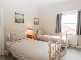 A bedroom with two beds and a bedside table at The Croft in Vowchurch near Peterchurch