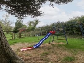 A playground with a slide and swingset in a garden at The Croft Vowchurch near Peterchurch