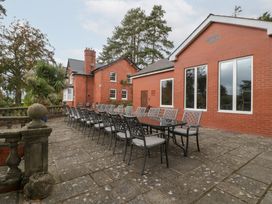 An outdoor patio with a large table and chairs at The Croft in Vowchurch near Peterchurch