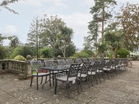An outdoor dining area with a long table and chairs at The Croft in Vowchurch near Peterchurch