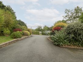 A driveway surrounded by bushes and a gate at The Croft in Vowchurch near Peterchurch