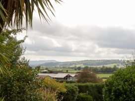A view of fields and buildings under a cloudy sky at The Croft in Vowchurch near Peterchurch