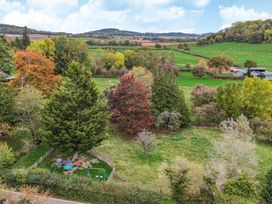 An outdoor area with trees and playground equipment at The Croft in Vowchurch near Peterchurch