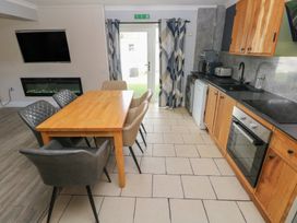 A kitchen with a dining table and modern appliances at Dylan's Court in Laugharne