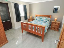 A bedroom with a bed and bedside tables at Dylan's Court in Laugharne