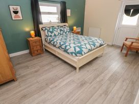 A bedroom with a bed and bedside table at Dylan's Court in Laugharne