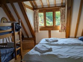 A bedroom with bunk bed and double bed at Hiraeth in Dolau near Llandrindod Wells