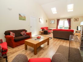 A living room with sofas and a wooden coffee table under skylights at 2 Pines Farm Cottages in Ulleskelf