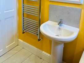 A bathroom with a sink and radiator at Corvette in Trearddur Bay