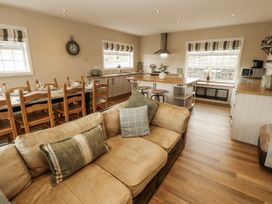 A kitchen with a dining area and appliances at White Gables in Great Clifton near Cockermouth