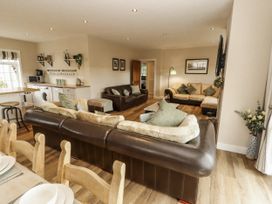 A living room with sofas and a dining table at White Gables Great Clifton near Cockermouth