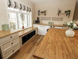 A kitchen with cabinets and appliances at White Gables Great Clifton near Cockermouth