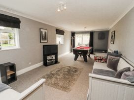 A snug with a pool table and sofa at White Gables in Great Clifton near Cockermouth