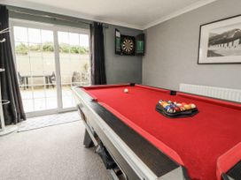 A games room with a pool table and dartboard at White Gables in Great Clifton near Cockermouth