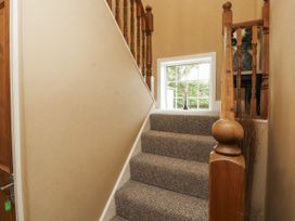 A staircase with a window and railing at White Gables in Great Clifton near Cockermouth