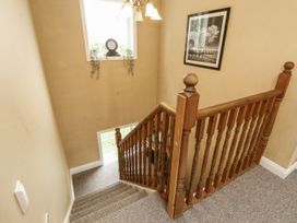 A staircase with a clock and picture frame at White Gables in Great Clifton near Cockermouth