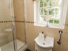 A bathroom with a shower and sink at White Gables in Great Clifton near Cockermouth