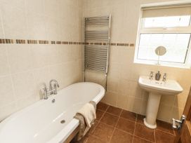 A bathroom with a bathtub and sink at White Gables in Great Clifton near Cockermouth