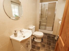 A bathroom with a sink, toilet, and shower at White Gables in Great Clifton near Cockermouth