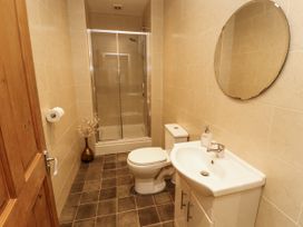 A bathroom with a shower, toilet, and sink at White Gables in Great Clifton near Cockermouth