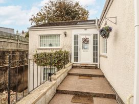 An exterior view of a door with steps and railing at White Gables in Great Clifton near Cockermouth