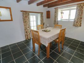 A dining room with table and chairs at Longhouse in St Keverne, Lizard Peninsula