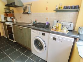 A kitchen with appliances and utensils at Longhouse St Keverne, Lizard Peninsula