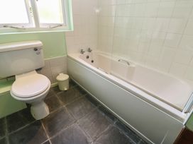 A bathroom with a toilet and a bathtub at Longhouse, St Keverne, Lizard Peninsula