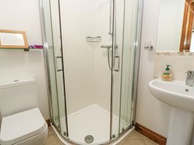 A bathroom with a shower enclosure toilet and sink at Shepherd's Barn Between Milborne St Andrew and Winterborne Whitechurch