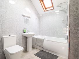 A bathroom with a toilet sink bathtub shower and skylight at Y Bwthyn in Llanbedr near Harlech