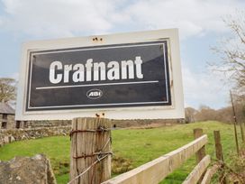 A sign with the word Crafnant on a wooden fence post in a rural grassy area at Y Bwthyn Llanbedr near Harlech