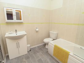 A bathroom with a sink and toilet at Daffodil Cottage, Caeathro near Caernarfon