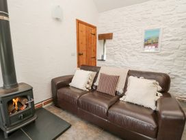 A living room with a sofa and a fireplace at Bwthyn Bach in Newport
