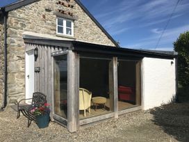 An exterior view of a building with a seating area at Y Cwtch Newport